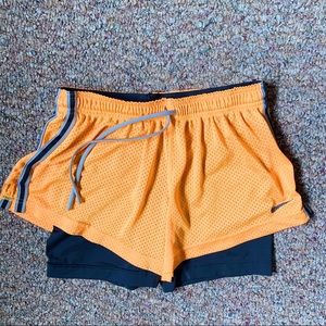 Orange Nike Pro athletic shorts